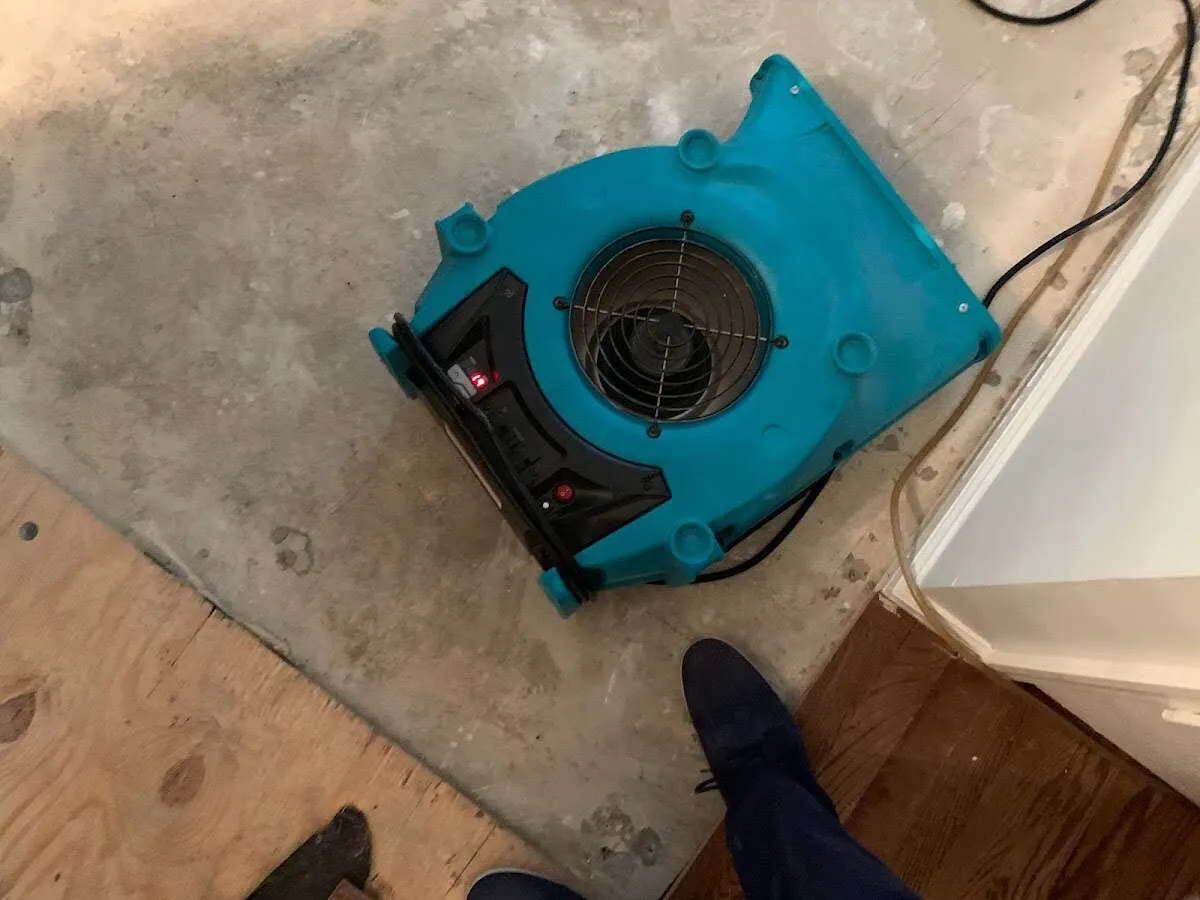 Air mover drying subfloor during Leak Detection & Repair in Perryton